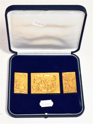 Lot 285 - A cased set of yellow metal carvings (3)