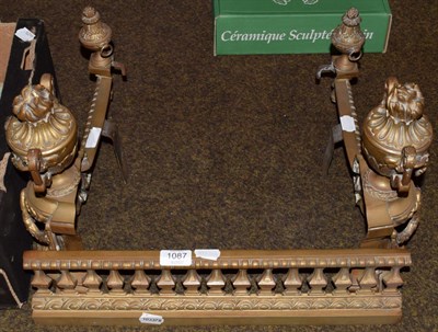 Lot 1087 - A late 19th century gilt brass fire surround with urn finials