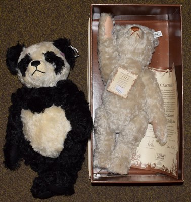 Lot 1100 - A modern Steiff 1911 replica teddy bear (certificate and boxed); and a black and white panda...