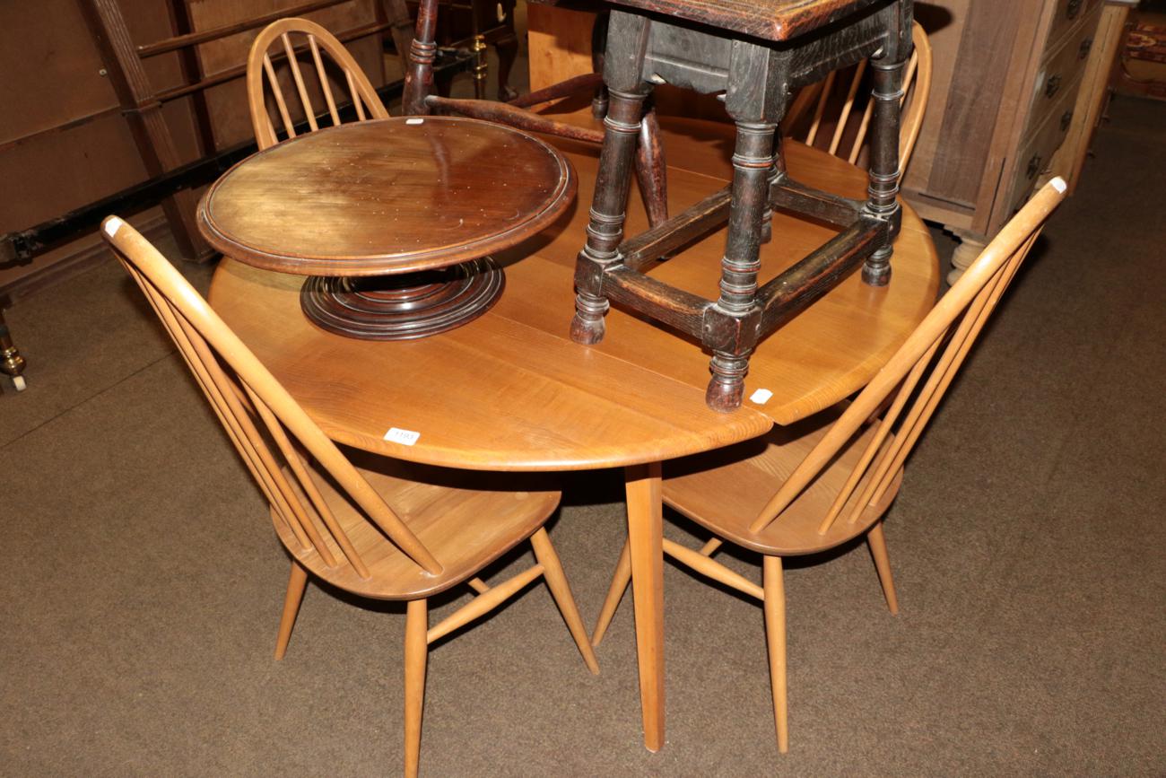 Lot 1193 - Ercol light elm drop leaf table, together with four matching chairs