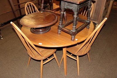 Lot 1193 - Ercol light elm drop leaf table, together with four matching chairs