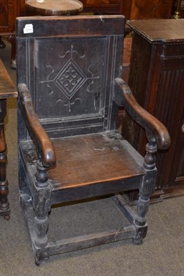 Lot 1215 - An 18th century oak Wainscott chair, carved panelled back, scroll arms, solid seat, turned supports