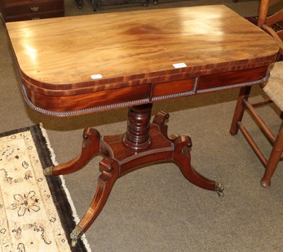 Lot 1216 - A Regency mahogany fold over card table