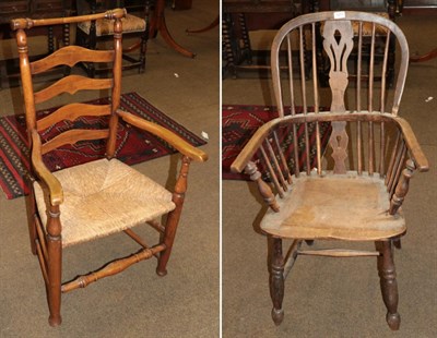 Lot 1217 - A ladder back rush seated chair and a yew and elm Windsor chair