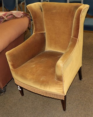 Lot 1224 - A Victorian armchair upholstered in yellow velvet on square tapering legs