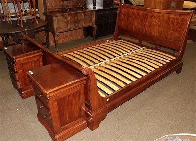Lot 1236 - A modern French cherry wood sleigh bed, and a modern pair of bedside cabinets