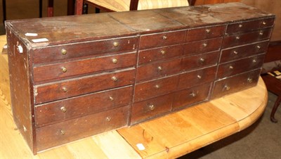 Lot 1241 - A 19th Century oak fifteen drawer chest, 107cm wide