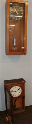 Lot 1262 - A 1950's Inducta pendulum wall clock, together with a late Victorian oak cased wall clock, with...