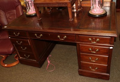 Lot 1265 - An early 20th Century mahogany partners desk, with brown leather writing surface, 151cm wide