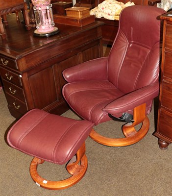 Lot 1267 - An Ekornes Stressless leather swivel chair, with matching footstool