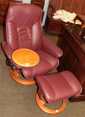 Lot 1268 - An Ekornes Stressless leather swivel chair, with adjustable tray and matching footstool