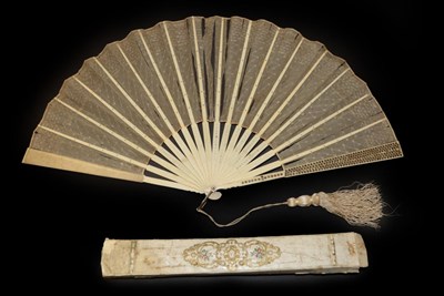 Lot 4049 - Four Fans, 19th to 20th Century, comprising a c.1830's horn brisé with pointed tips, carved...