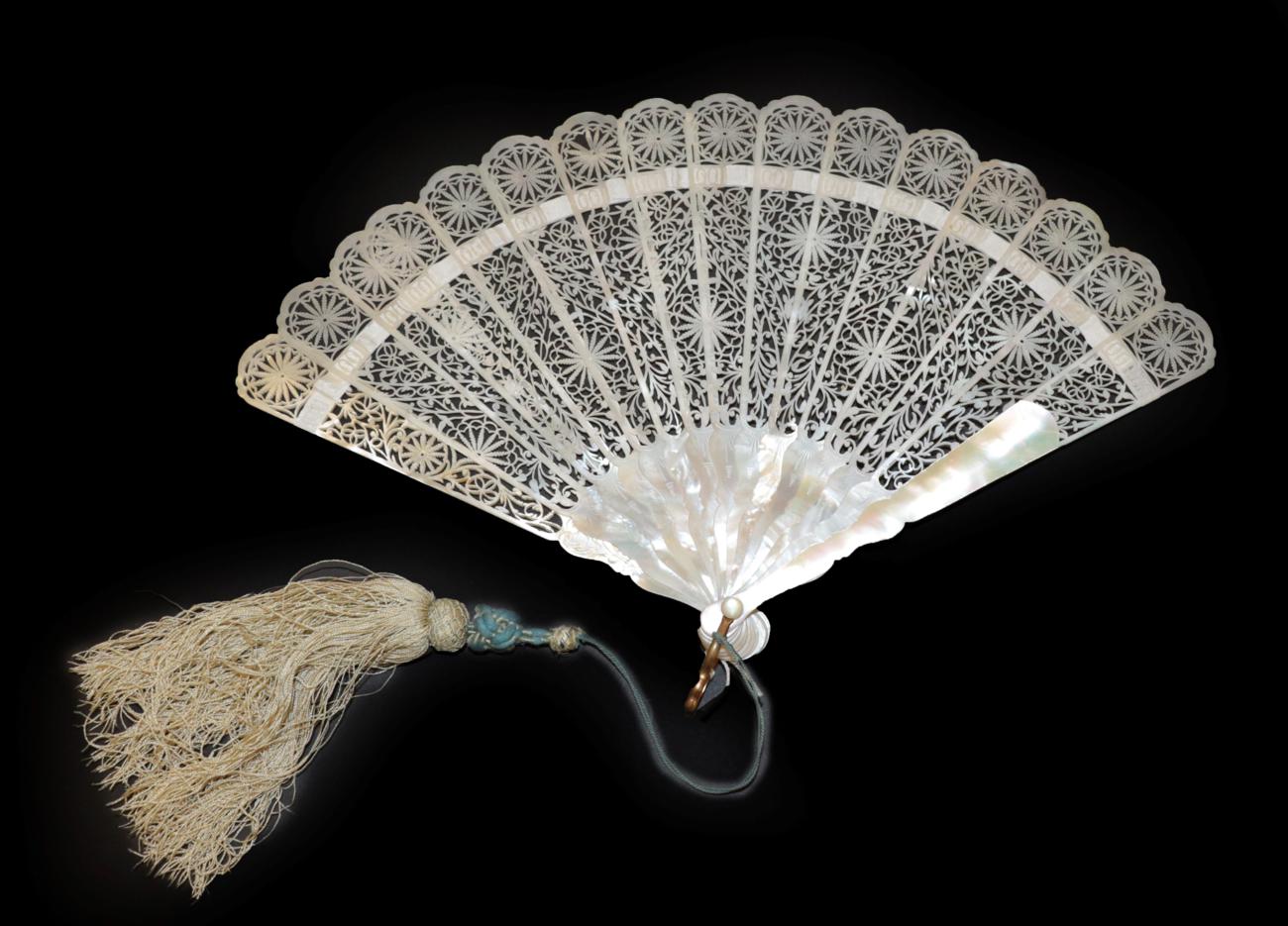 Lot 4077 - A Scarce Carved and Pierced Cream Mother-of-Pearl Fan, with iridescent shading when held to the...