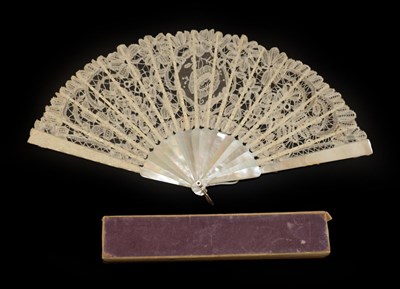 Lot 4099 - An Unusual Circa 1880's Lace Fan, the leaf a tape lace with varied needle lace fillings,...