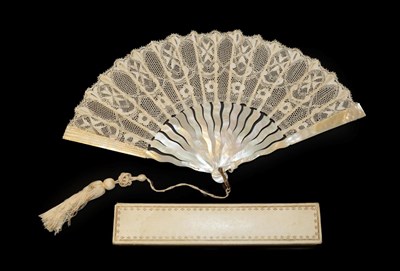 Lot 4106 - A Circa 1900/1910 Maltese Silk Lace Fan, the leaf mounted on white mother-of-pearl. The...