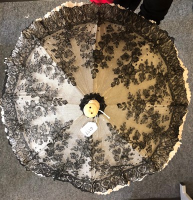 Lot 4117 - A Good, Large, Late 19th Century Black Chantilly Lace Parasol, the lace cover laid over cream silk