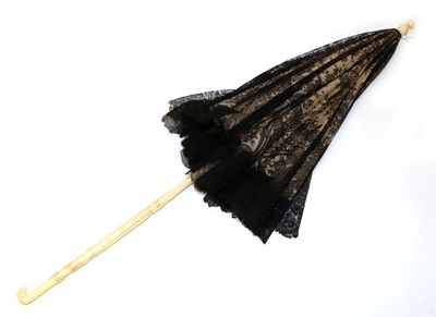 Lot 4118 - A Mid-19th Century Folding Parasol, the very fine black lace cover of fine Chantilly of...