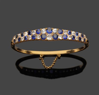 Lot 578 - A Late 19th Century/Early 20th Century Sapphire and Diamond Bangle, two rows of graduated old...