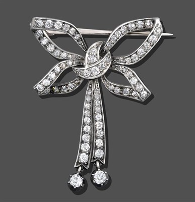 Lot 2019 - A Diamond Bow Brooch, set throughout with old cut and rose cut diamonds, the two bow tails...