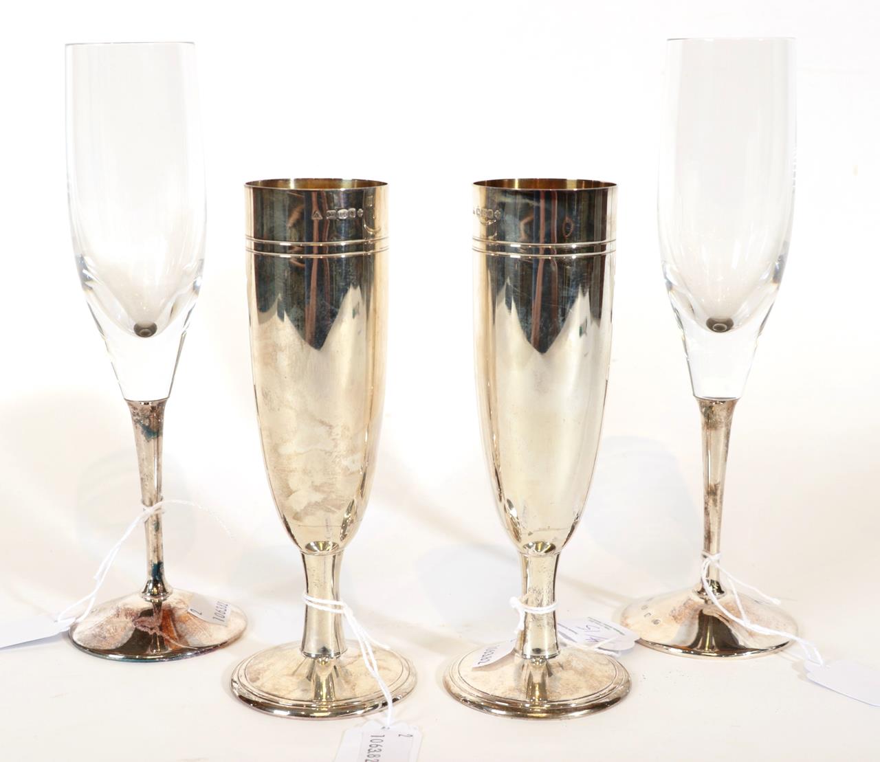 Lot 15 - A Pair of Elizabeth II Silver Champagne-Flutes and a Pair of Elizabeth II Silver-Mounted Glass...
