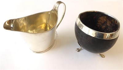 Lot 30 - A George III Silver Cream-Jug by John Scofield, London, 1794, helmet shaped and with reeded rim and
