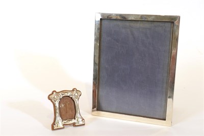 Lot 44 - An Edward VII Silver Photograph-Frame, by William Hutton and Sons, London, 1903, shaped oblong, the