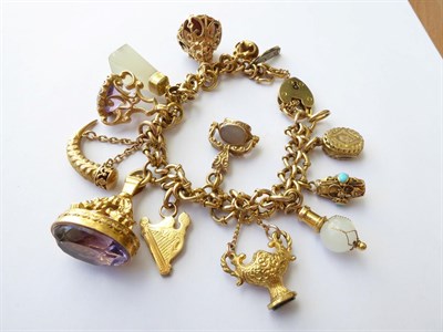 Lot 102 - A Charm Bracelet, with applied plaques stamped '9CT', hung with thirteen charms including...