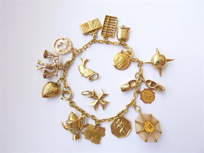 Lot 105 - A Charm Bracelet, stamped '9' and '.375', hung with various charms including a bell, clogs etc; and