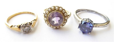 Lot 142 - An Amethyst and Seed Pearl Ring, unmarked, finger size L1/2; A Diamond Solitaire Ring, stamped...