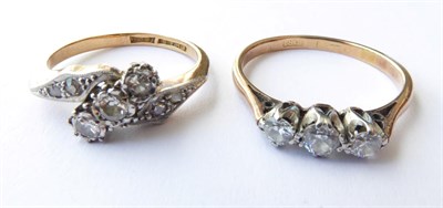 Lot 165 - A Diamond Three Stone Ring, stamped '18CT', finger size M; and A Diamond Three Stone Twist...