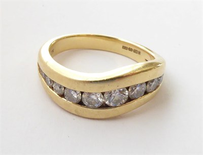Lot 167 - An 18 Carat Gold Diamond Ring, graduated round brilliant cut diamonds channel set in an...