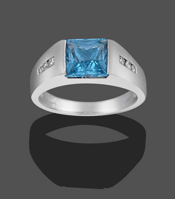 Lot 2008 - An 18 Carat White Gold Blue Topaz and Diamond Ring, the scissor cut blue topaz in a white...