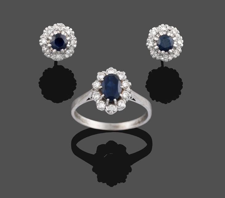 Lot 2021 - A Sapphire and Diamond Cluster Ring, the oval cut sapphire within a border of round brilliant...
