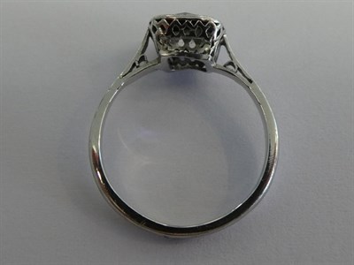 Lot 2023 - A Diamond Solitaire Ring, the old cut diamond in a white claw and rubbed over setting, to a tapered