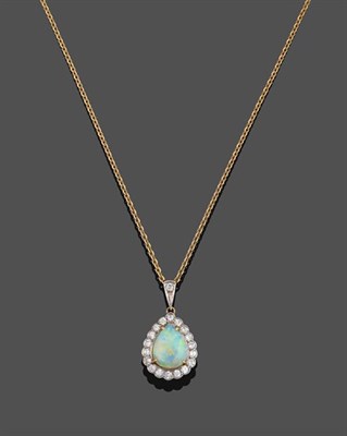 Lot 2025 - An 18 Carat Gold Opal and Diamond Cluster Pendant on Chain, the pear cut cabochon opal in a...