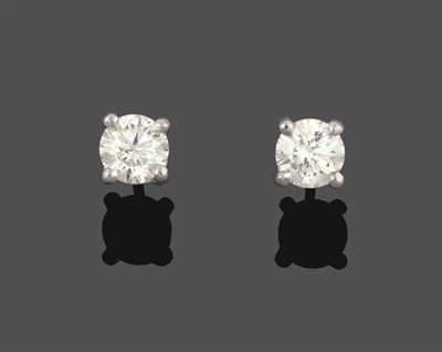 Lot 2032 - A Pair of Diamond Solitaire Earrings, the round brilliant cut diamonds in white four claw settings