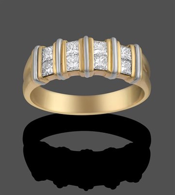 Lot 2033 - An 18 Carat Gold Diamond Ring, four pairs of princess cut diamonds spaced by fixed yellow bars,...
