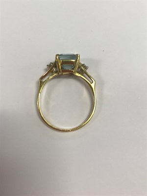 Lot 2034 - An 18 Carat Gold Aquamarine and Diamond Ring, the emerald-cut aquamarine in a yellow claw...