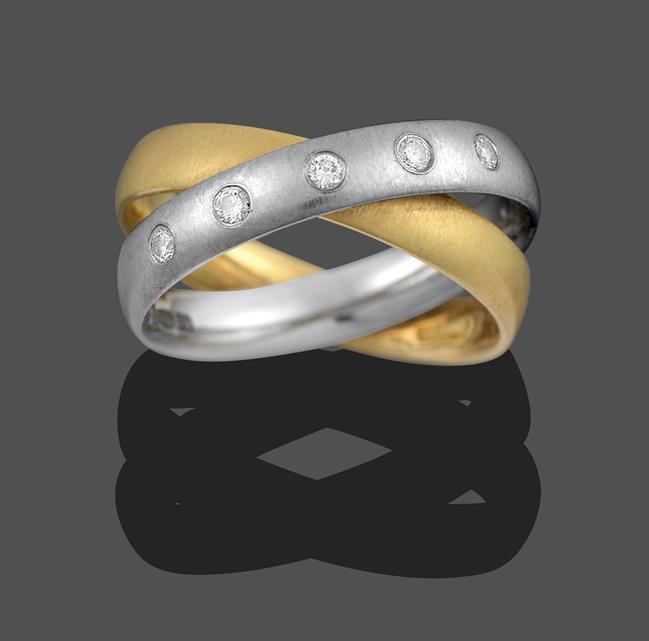Lot 2035 - A Diamond Crossover Ring, a yellow plain polished band crossed by a platinum plain polished...