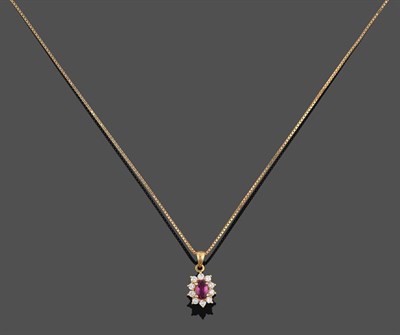 Lot 2038 - A Ruby and Diamond Cluster Pendant on Chain, the oval cut ruby within a border of round...