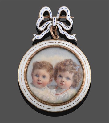 Lot 2048 - An Enamel Portrait Brooch, a bow motif enamelled in blue and white suspends a circular frame...