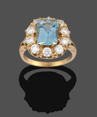 Lot 2050 - An Aquamarine and Diamond Cluster Ring, the cushion cut aquamarine within a border of round...