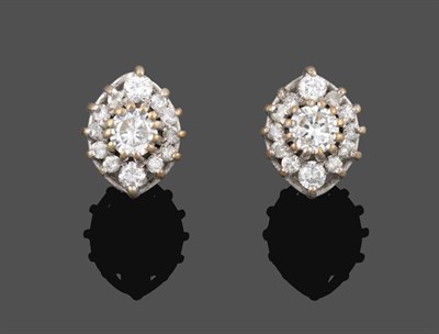 Lot 2065 - A Pair of 18 Carat White Gold Diamond Cluster Earrings, a round brilliant cut diamond within a...