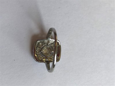 Lot 2069 - An Art Deco Style Diamond Ring, a round brilliant cut diamond within a diamond set pierced...