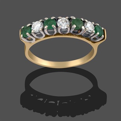 Lot 2080 - An 18 Carat Gold Emerald and Diamond Seven Stone Ring, four round cut emeralds alternate with round