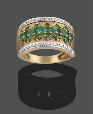 Lot 2081 - A 9 Carat Gold Emerald and Diamond Ring, a row of round cut emeralds within two rows of smaller...