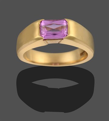 Lot 2090 - An 18 Carat Gold Pink Sapphire Ring, the emerald-cut pink sapphire in a yellow rubbed over...