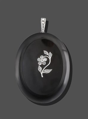 Lot 2098 - A Jet and Diamond Pendant, the oval polished jet plaque with a rose cut and eight-cut diamond...