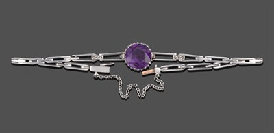 Lot 2100 - An Amethyst and Diamond Bracelet, a round cut amethyst in a white claw setting, to tapering...