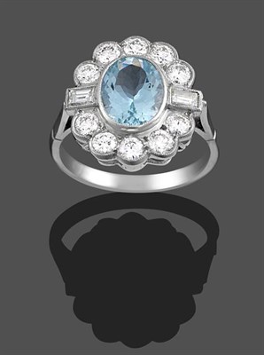 Lot 2107 - An Aquamarine and Diamond Cluster Ring, the oval cut aquamarine within a border of round...